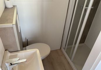 Baño compacto en Chalets at Marina Parcs Almere con inodoro, lavabo y ducha, Países Bajos.