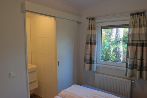 Camera da letto nel Forest park chalet 8p con vista sul bosco e bagno, Holiday park De Kleine Belties, Olanda.