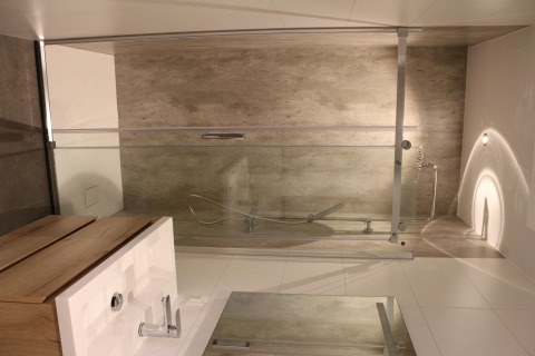 Modern bathroom at Forest Cube, Holiday Park BreeBronne, featuring a bathtub and wooden sink area.