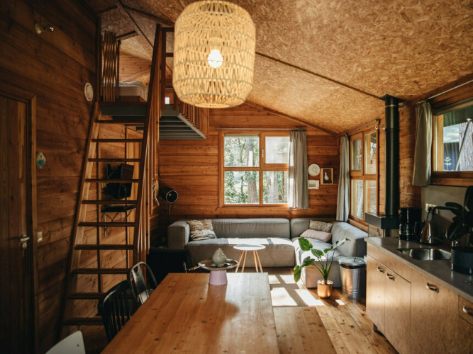 Cozy safari tent cabin interior at Youpi! Lodge, Beerze Bulten, Netherlands, with wood decor and loft.