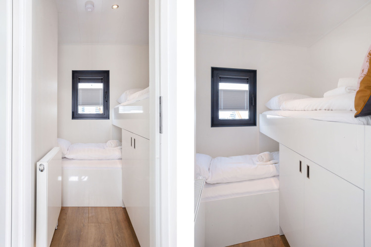 Modern bunk bed sleeping area on Houseboat Aqua Dolce at Welcome In - Friesland, Netherlands, with white decor.