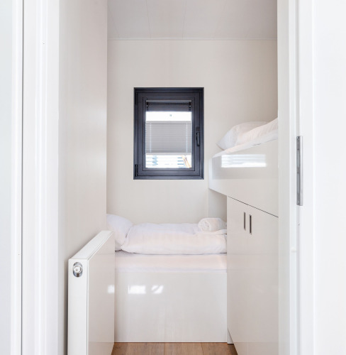 Bright, modern sleeping area with window and bunk beds in Houseboat Aqua Dolce, Friesland, Netherlands.