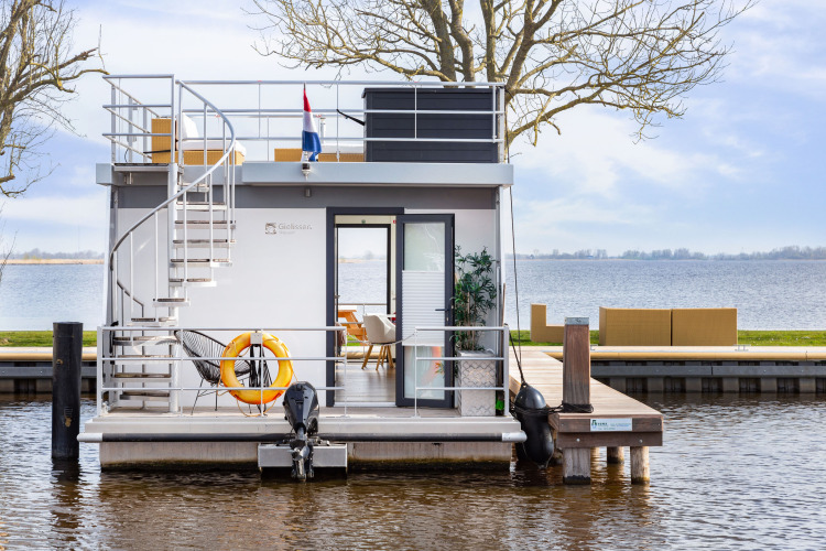 Houseboat Aqua Dolce at Welcome In - Friesland, Netherlands, featuring a sleek terrace and lake view.