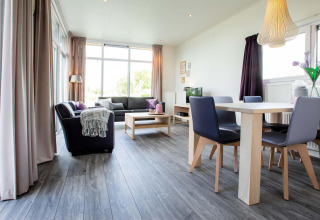 Helles, modernes Wohnzimmer in der Lodge Module Wellness (Spa) im Recreatiepark het Esmeer, Niederlande.