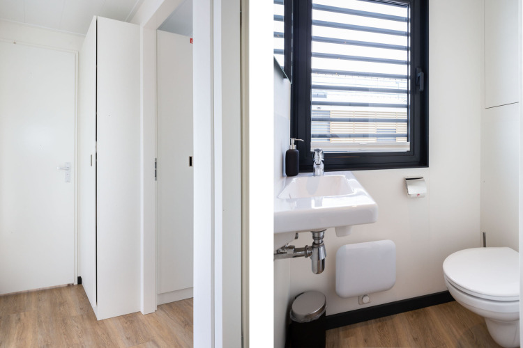Interior of Houseboat 'de Valreep' at Welcome In - Friesland, Netherlands, showing modern bathroom and hallway.