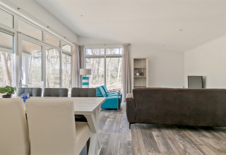 Bright, modern living area inside Forest park chalet at Holiday park De Kleine Belties, Netherlands.