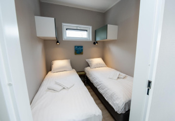 Bright twin room with two single beds at Houseboat 'Riggelbrug' at Welcome In - Friesland, Netherlands.
