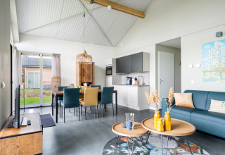 Modern lodge Anker at Tusken de Marren in the Netherlands featuring open kitchen, dining, and living area.