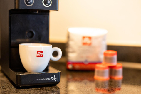 Nærbillede af en illy kaffemaskine og kop i en lille hytte ved Wellness Lodge, Hof van Salland, Holland.