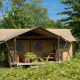 Luxury lodge safari tent with porch set in lush greenery at Holiday park De Kleine Belties, Netherlands.