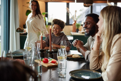 A family enjoys a meal together at Unbrick One | Sauna at Brinckerduyn lodge in the Netherlands.
