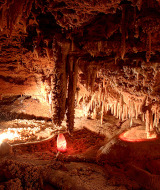 Cueva con estalactitas cerca de Varen, Occitania, Francia, iluminada por lámparas que realzan su belleza natural.