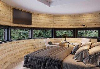 Slaapkamer in The Nutshell tiny house met panoramische ramen, sauna en hot tub in Den Blanken, Nederland.