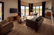Wheelchair-accessible modern living room in a holiday villa, with contemporary furniture and nature views.