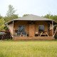 Safari-Zelt Villatent Cottage auf Camping 't Geuldal in den Niederlanden, mit Veranda und grüner Wiese.