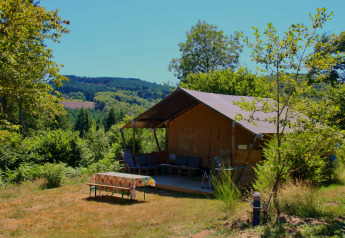 Safari tent Greenlodge at Camping Domaine La Chabanne in France with a scenic view of hills and nature.
