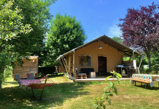 Safari Greenlodge tent with private bathroom at Camping Domaine La Chabanne in France, surrounded by nature.