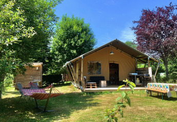 Safari Greenlodge tent with private bathroom at Camping Domaine La Chabanne in France, surrounded by nature.