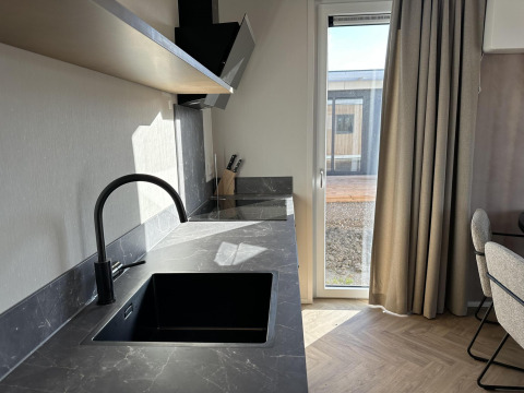 Modern kitchen countertop and sink at Zonneweelde Lodge XL at Camping Zonneweelde, Netherlands