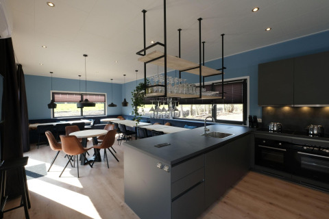 Cocina y comedor modernos y luminosos en la cabaña Amalia Familia en Hofparken Wiltershaar, Países Bajos.