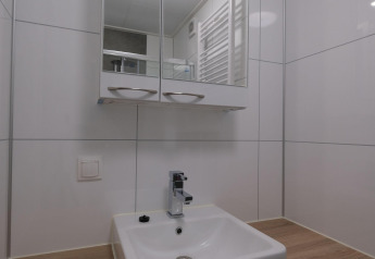Modern bathroom sink with mirror cabinet at Amalia Familia lodge, Hofparken Wiltershaar, Netherlands.