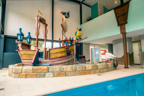 Indoor pool area with pirate ship play structure at L-Pavilion 6, De Biesbosch Lodge, Netherlands.