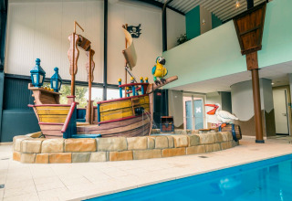 Indoor pool area with pirate ship play structure at L-Pavilion 6, De Biesbosch Lodge, Netherlands.