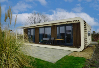 Photo of the Mode Wellness 2 lodge at Marina Strandbad in the Netherlands, featuring modern design and terrace.