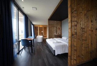 Moderne lodge Mode Wellness 2 bij Marina Strandbad in Nederland met houten inrichting en losstaand bad.