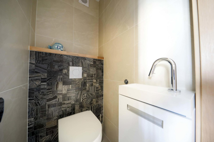 Baño moderno con inodoro y lavabo en la casa flotante Water Lodge 4 en Marina Strandbad, Países Bajos.