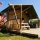 Safari tent with wooden deck at Wilsumer Berge lodge in Germany, photographed on a sunny day.