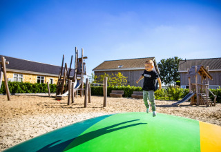 Niño saltando en un cojín inflable del parque infantil en Biebosch Lodge, Resort Mooi Bemelen, Países Bajos.