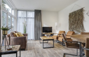 Moderne woonkamer van een Tiny House in Bospark Markelo, Nederland, met rustieke en gezellige inrichting.