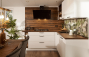Modern kitchen interior at Cubus Lodge, Bospark Markelo, Netherlands, with wood accents and white cabinets.