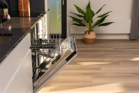 Open dishwasher in a modern kitchen at Vogellodge + hot tub in Holiday Resort 't Schuttenbelt, Netherlands.