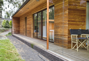 Vista esterna di Woody Lodge Florian presso Holiday Resort 't Schuttenbelt nei Paesi Bassi, rivestimento in legno.