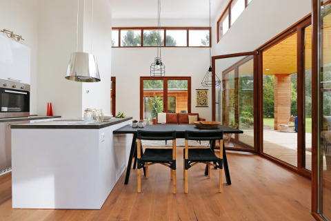 Bright, modern living room and kitchen inside Woody Lodge Valerie tiny house at Holiday Resort 't Schuttenbelt, Netherlands.