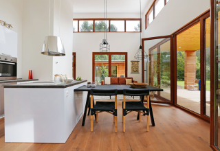 Bright, modern living room and kitchen inside Woody Lodge Valerie tiny house at Holiday Resort 't Schuttenbelt, Netherlands.
