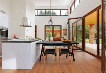 Lichte, moderne woonkamer en keuken in tiny house Woody Lodge Valerie op Holiday Resort 't Schuttenbelt, Nederland.