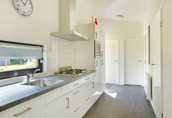 Modern kitchen interior at Lodge Grand Modern with Finnish sauna at Holiday Park De Lochemse Berg, Netherlands.