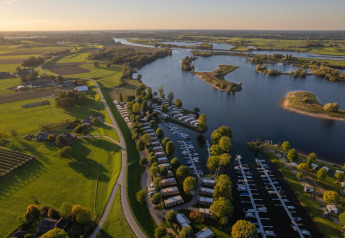 Aerial view of MarinaPark Bad Nederrijn in the Netherlands with the marina, villas, and river landscape.