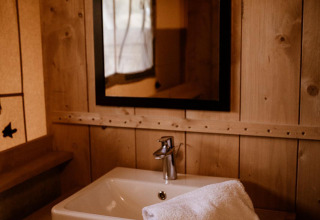 Lavabo y espejo en la tienda safari Groupaccommodation 'de Blokhut' en el Holiday park Eigen Wijze, Países Bajos.