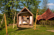 Tiny boutique suite at Holiday Park Mölke, Netherlands, with cozy interior and lush green surroundings.