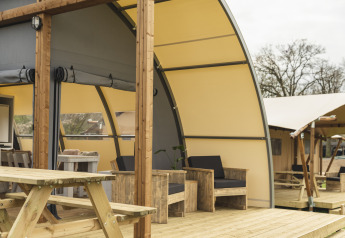 Outdoor seating at Panorama Lodge + bathroom, Holiday Park Mölke, Netherlands, with wooden furniture.