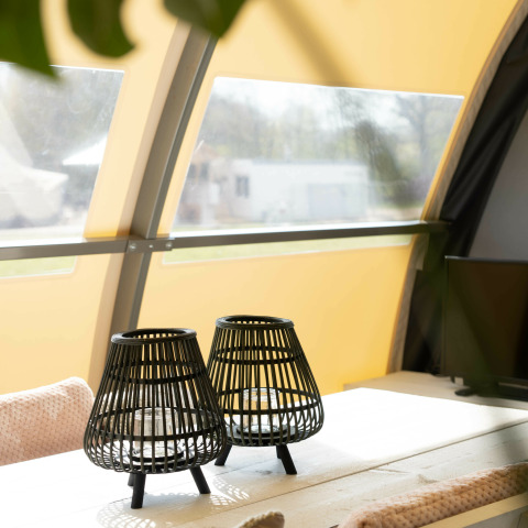 Deux lanternes noires sur une table à Panorama Lodge + salle de bain au Holiday Park Mölke, Pays-Bas, ensoleillé.