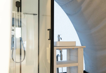 Modern bathroom at Panorama Lodge, Holiday Park Mölke, Netherlands, featuring a shower cabin and sink.