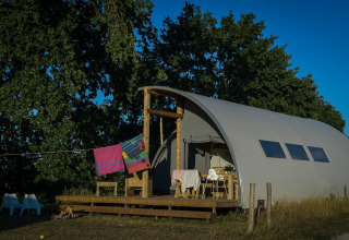 Panorama Lodge met badkamer bij Holiday Park Mölke in Nederland, omringd door groen en houten terras.