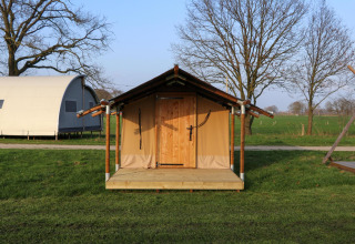 Safari tent at Pop-up glamping: Neighbor's Awaji, Holiday Park Mölke, Netherlands, with fields in view.