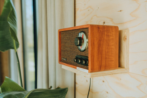 Radio retro de madera en la pared de la cabaña Duunroos, Holiday park De Klepperstee, Países Bajos.