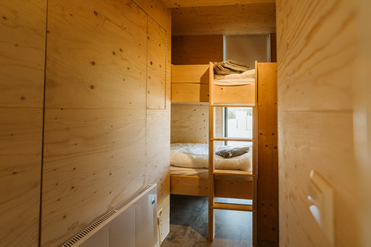 Cozy wooden bunk beds inside Kleproos lodge at Holiday park De Klepperstee in the Netherlands.